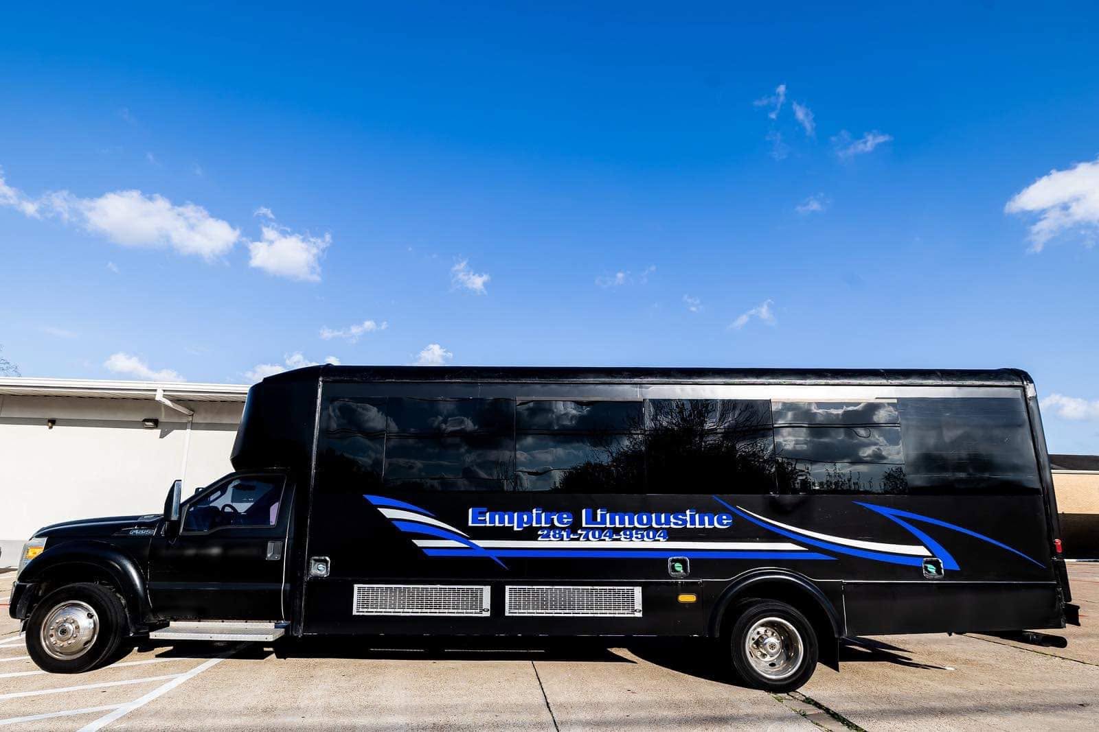 The black Empire Limousine party bus with blue and white livery